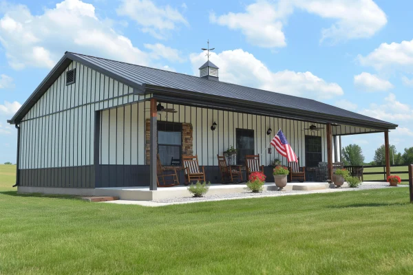 Beautiful 30x40 Barndominium on a grassy lawn. With flowers, rocking chairs and a flag at the front overhang before the home entrance.